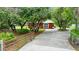Long driveway leading to the home, enhanced by the mature trees and landscaping that surround the property at 9130 Madrid Rd, Weeki Wachee, FL 34613