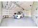 Spacious garage with unfinished insulation, holding a vintage truck with potential for customization or restoration projects at 9130 Madrid Rd, Weeki Wachee, FL 34613