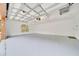 Clean, bright garage featuring smooth, painted concrete floor and a window providing natural light at 9130 Madrid Rd, Weeki Wachee, FL 34613