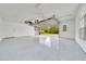 A clean, spacious garage with an open door overlooks the home's manicured front lawn at 9130 Madrid Rd, Weeki Wachee, FL 34613