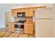 Bright kitchen with wood cabinets, stainless steel appliances and wood floors at 9130 Madrid Rd, Weeki Wachee, FL 34613