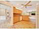 Kitchen with stainless appliances, wood cabinets, dishwasher, and view to living room at 9130 Madrid Rd, Weeki Wachee, FL 34613