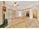 Bright living room with fan and french doors and mirrored wall at 9130 Madrid Rd, Weeki Wachee, FL 34613