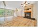 Open living room with fireplace, large windows, and chandelier at 9130 Madrid Rd, Weeki Wachee, FL 34613
