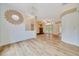Bright living room with hardwood floors, fireplace, and chandelier at 9130 Madrid Rd, Weeki Wachee, FL 34613