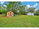 Spacious yard with two storage buildings and lush green grass at 9130 Madrid Rd, Weeki Wachee, FL 34613