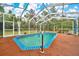 A clear blue pool is surrounded by a screened enclosure and comfortable outdoor seating at 9130 Madrid Rd, Weeki Wachee, FL 34613
