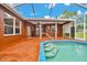 A backyard pool features built-in steps and a screened enclosure for relaxing outdoor living at 9130 Madrid Rd, Weeki Wachee, FL 34613