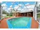 Screened-in pool with brick patio and partial shade coverage at 9130 Madrid Rd, Weeki Wachee, FL 34613