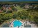 An aerial view showcases the pool, golf course, and serene natural surroundings of the community at 9719 Oakwood Hills Ct, New Port Richey, FL 34655