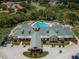 Aerial view of the community clubhouse with pool, golf course, and lush landscaping at 9719 Oakwood Hills Ct, New Port Richey, FL 34655
