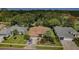 Aerial view of a single-story home with mature trees, well-manicured landscaping and a nearby golf course at 9719 Oakwood Hills Ct, New Port Richey, FL 34655