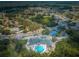 Aerial view of the community clubhouse, tennis courts, golf course, and surrounding neighborhood at 9719 Oakwood Hills Ct, New Port Richey, FL 34655