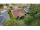 Aerial view of home showcasing landscaping, roof, and screened in lanai at 9719 Oakwood Hills Ct, New Port Richey, FL 34655
