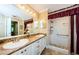 Bathroom with double sinks, granite countertops, and walk-in shower at 9719 Oakwood Hills Ct, New Port Richey, FL 34655