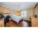 Bedroom with hardwood floors and built in desk and shelving at 9719 Oakwood Hills Ct, New Port Richey, FL 34655