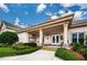 Welcoming clubhouse exterior with manicured landscaping, covered entrance, and inviting pathway at 9719 Oakwood Hills Ct, New Port Richey, FL 34655
