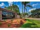 Entrance sign to Timber Greens is surrounded by lush greenery and landscaping at 9719 Oakwood Hills Ct, New Port Richey, FL 34655