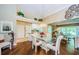 Charming dining area adjacent to kitchen, featuring glass table and views of the living spaces at 9719 Oakwood Hills Ct, New Port Richey, FL 34655