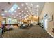 Spacious event room with ample seating, natural light, and a stage area at 9719 Oakwood Hills Ct, New Port Richey, FL 34655