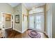 Bright foyer showcasing elegant hardwood floors, decorative glass doors, and stylish interior design at 9719 Oakwood Hills Ct, New Port Richey, FL 34655