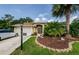 Beautiful home featuring a well-kept lawn, mature palm trees, and a warm, inviting front entrance at 9719 Oakwood Hills Ct, New Port Richey, FL 34655