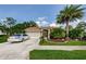 Charming one-story home with well-manicured lawn, mature palm trees, and a two-car garage at 9719 Oakwood Hills Ct, New Port Richey, FL 34655