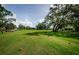 Scenic view of golf course from the tee box on a sunny day at 9719 Oakwood Hills Ct, New Port Richey, FL 34655
