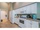 Efficient kitchen with stainless appliances, plenty of cabinet space, and adjacent laundry room at 9719 Oakwood Hills Ct, New Port Richey, FL 34655