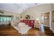 Open living room with wood floors, a high ceiling, comfortable seating, and great natural light at 9719 Oakwood Hills Ct, New Port Richey, FL 34655
