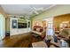 Open living room with hardwood floors, built in entertainment center, and bright natural light at 9719 Oakwood Hills Ct, New Port Richey, FL 34655