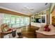 Comfortable living room featuring hardwood floors, large windows, and a media center at 9719 Oakwood Hills Ct, New Port Richey, FL 34655