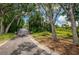 Picturesque walking path featuring a wooden bridge, lush greenery, and mature trees, perfect for peaceful strolls at 9719 Oakwood Hills Ct, New Port Richey, FL 34655