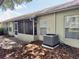 Exterior view of the house featuring an air conditioning unit, and a view of the screened patio at 18142 Baywood Forest Dr, Hudson, FL 34667