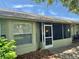 Exterior view of the house with a screened patio and a view of the landscaped backyard at 18142 Baywood Forest Dr, Hudson, FL 34667