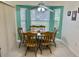 Cozy kitchen dining area with a bay window, wooden table and chairs, and neutral walls at 18142 Baywood Forest Dr, Hudson, FL 34667