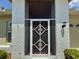 Close-up of front door with white brick and black details at 18142 Baywood Forest Dr, Hudson, FL 34667