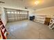 Spacious garage with epoxy flooring, shelving units, and an automatic garage door at 18142 Baywood Forest Dr, Hudson, FL 34667