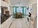 Bright kitchen with white cabinets, granite countertops, and a breakfast nook area at 18142 Baywood Forest Dr, Hudson, FL 34667