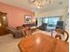 Cozy living room with a dining area and sliding glass doors leading to the patio at 18142 Baywood Forest Dr, Hudson, FL 34667