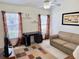 This living room has great natural light from the windows and a ceiling fan at 18142 Baywood Forest Dr, Hudson, FL 34667