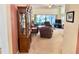 Spacious living room featuring neutral carpet, a built-in hutch, and sliding glass doors to the patio at 18142 Baywood Forest Dr, Hudson, FL 34667