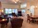 Comfortable living room featuring lots of seating and light from sliding glass doors at 18142 Baywood Forest Dr, Hudson, FL 34667