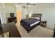 This main bedroom has carpet, ceiling fan, an en suite bathroom, and closet at 18142 Baywood Forest Dr, Hudson, FL 34667