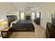 This main bedroom has carpet, ceiling fan, and plenty of closet space for storage at 18142 Baywood Forest Dr, Hudson, FL 34667