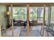 View of a screened patio with a rug and table with chairs accessible through sliding glass doors at 18142 Baywood Forest Dr, Hudson, FL 34667