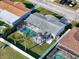 Aerial view of a home with pool, fenced yard, surrounded by other residential properties in a neighborhood setting at 10029 Freestone Ln, Port Richey, FL 34668
