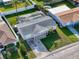 Beautiful aerial view of property with pool, fenced yard, and lush landscaping at 10029 Freestone Ln, Port Richey, FL 34668