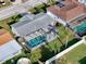 An aerial view highlights the pool, green lawn, and location within a community with nearby amenities at 10029 Freestone Ln, Port Richey, FL 34668