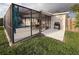 Spacious backyard featuring a screened-in patio with dining, a grill, and a private pool for outdoor entertainment at 10029 Freestone Ln, Port Richey, FL 34668